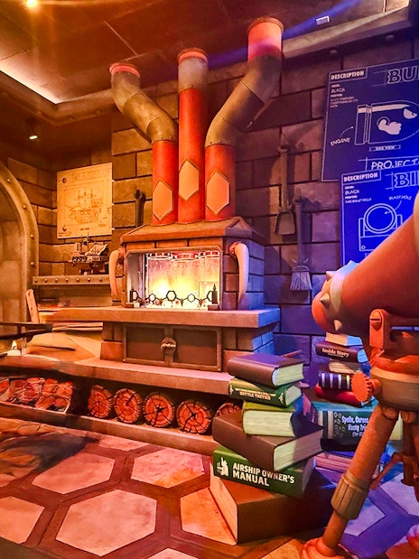 Universal Studios Hollywood attraction with telescope and stacked books in themed room.
