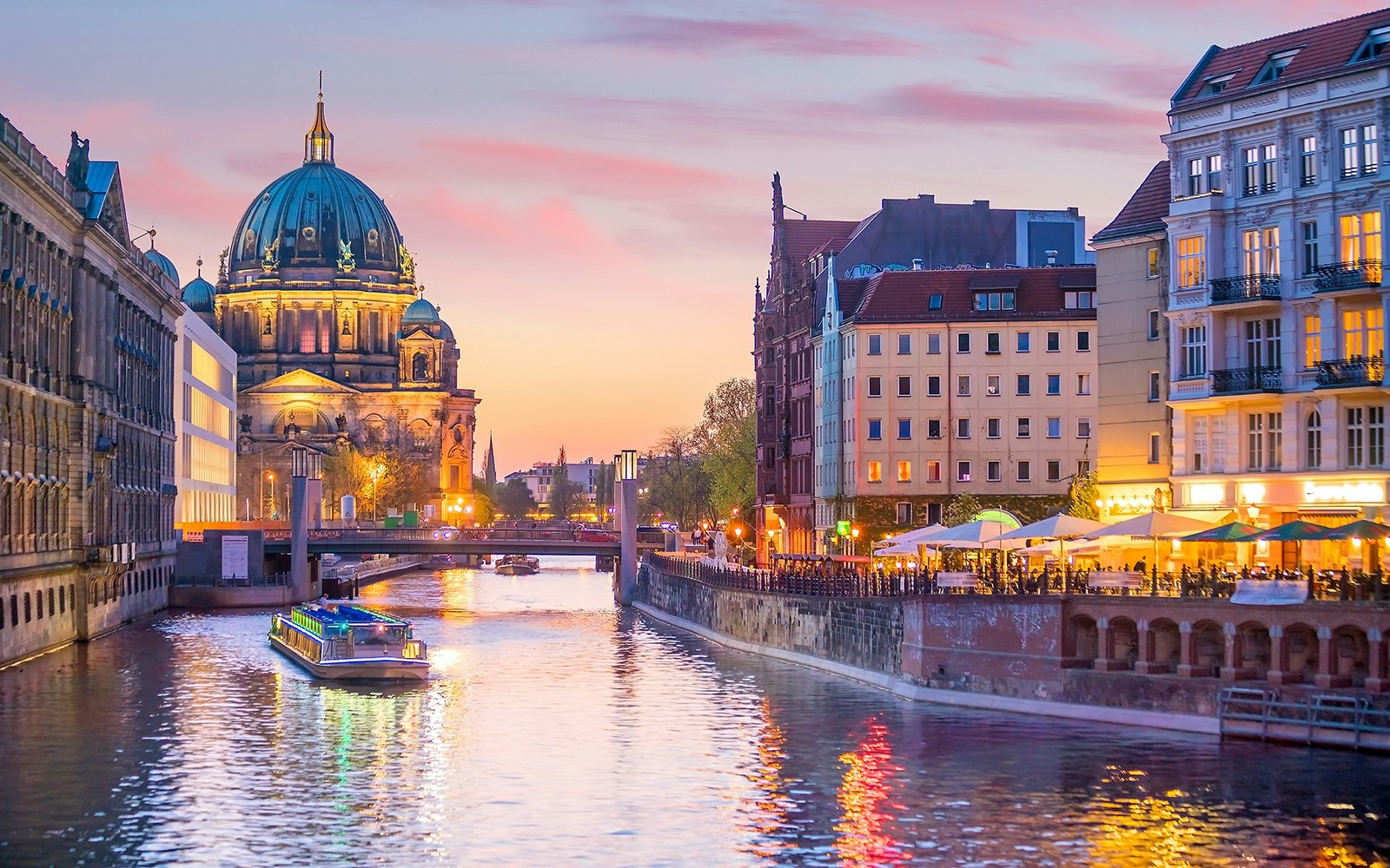 Cruise boat on the Spree River with Berlin Cathedral in the background, Berlin, Germany.