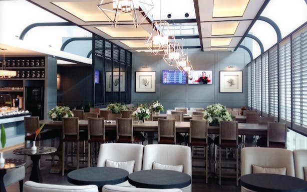 Coral Executive Lounge seating area at Phuket International Airport T2 with dining tables and decor.