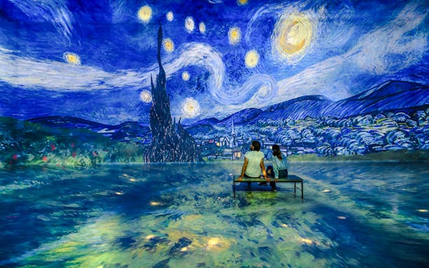 Guests viewing Van Gogh's 'Starry Night' at Frameless London exhibit.