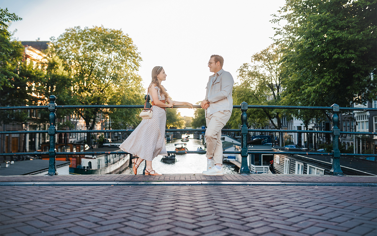 Couple posing on Magere Brug in Amsterdam during a professional photoshoot.