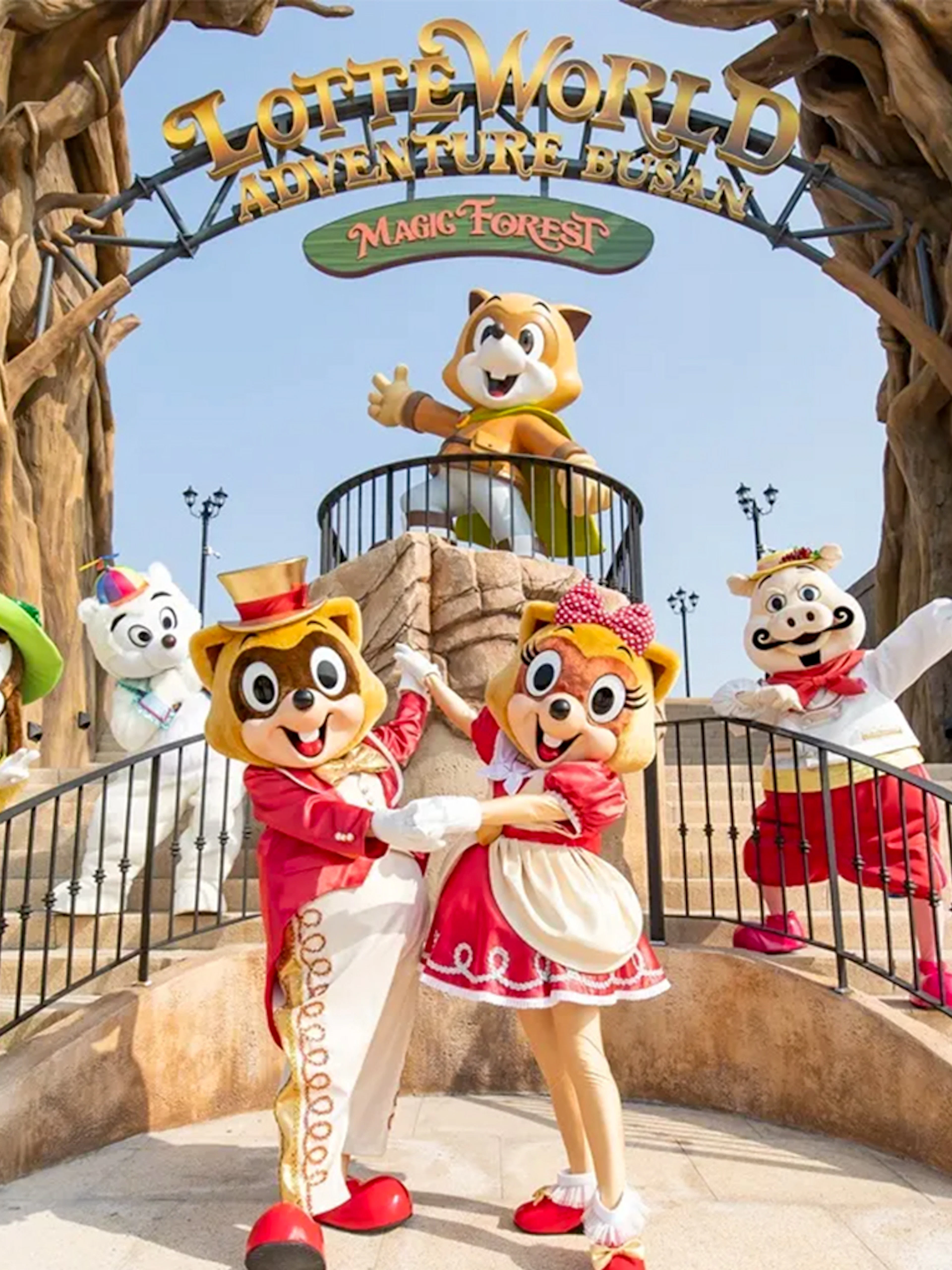 Characters in colorful costumes at Lotte World Adventure Busan entrance.