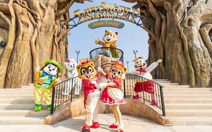 Characters in colorful costumes at Lotte World Adventure Busan entrance.