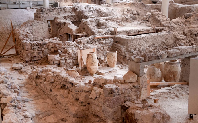 Akrotiri Archaeological Site ruins with ancient pottery in Santorini, Greece.