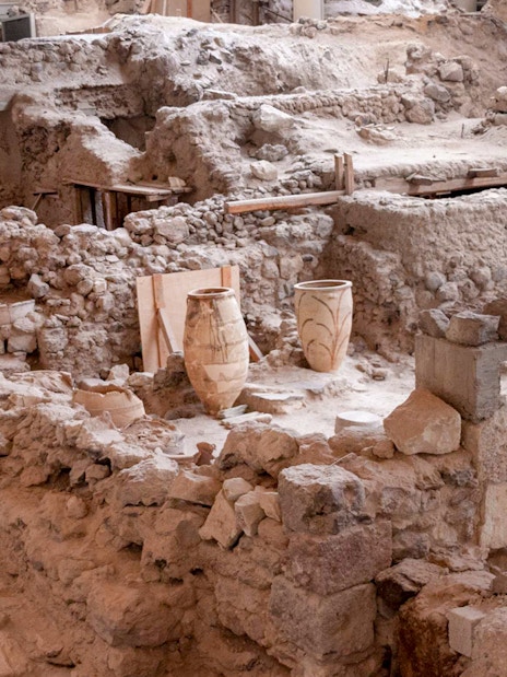 Akrotiri Archaeological Site ruins with ancient pottery in Santorini, Greece.