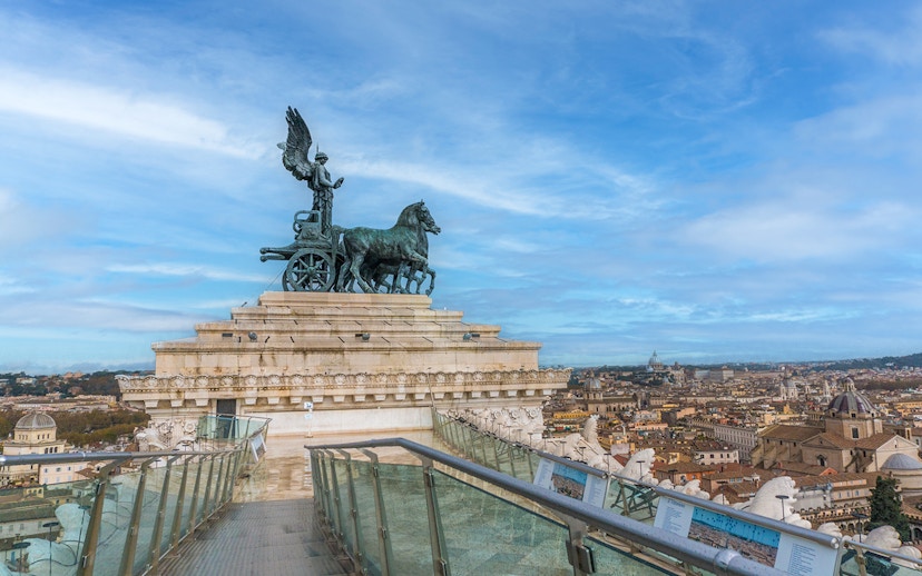 View from Altar of the Fatherland, Rome, with chariot statue and cityscape.