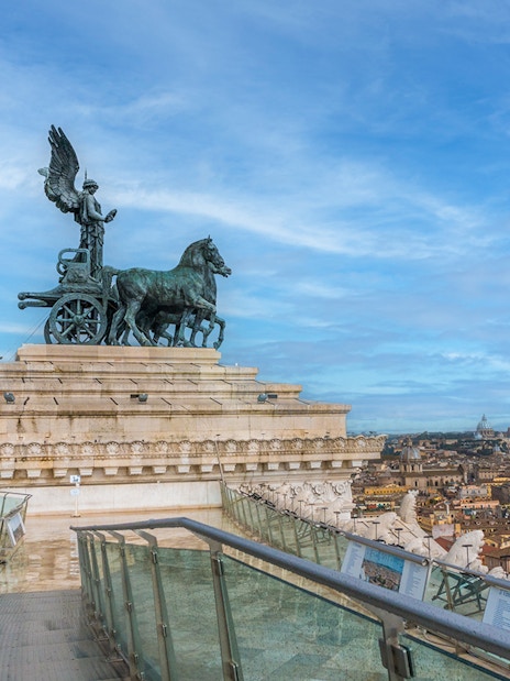 View from Altar of the Fatherland, Rome, with chariot statue and cityscape.