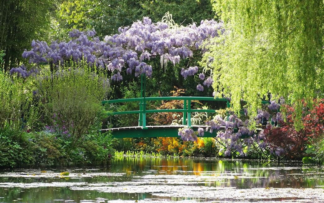 Giverny garden with green bridge and wisteria, part of Monet's House tour from Paris.