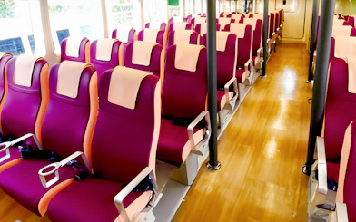 Ferry seating area with rows of red seats at Tanah Merah Terminal for Sindo Ferry tickets.