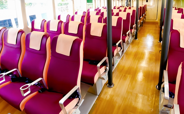 Ferry seating area with rows of red seats at Tanah Merah Terminal for Sindo Ferry tickets.