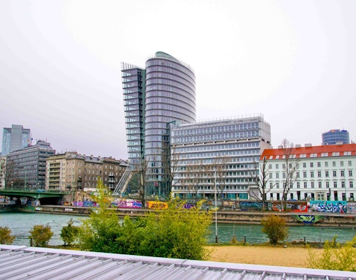 Uniqa Tower in Vienna, Austria, with modern glass architecture reflecting the cityscape.