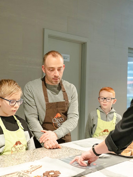 Guests learning chocolate making at Choco-Story Brussels Museum workshop.