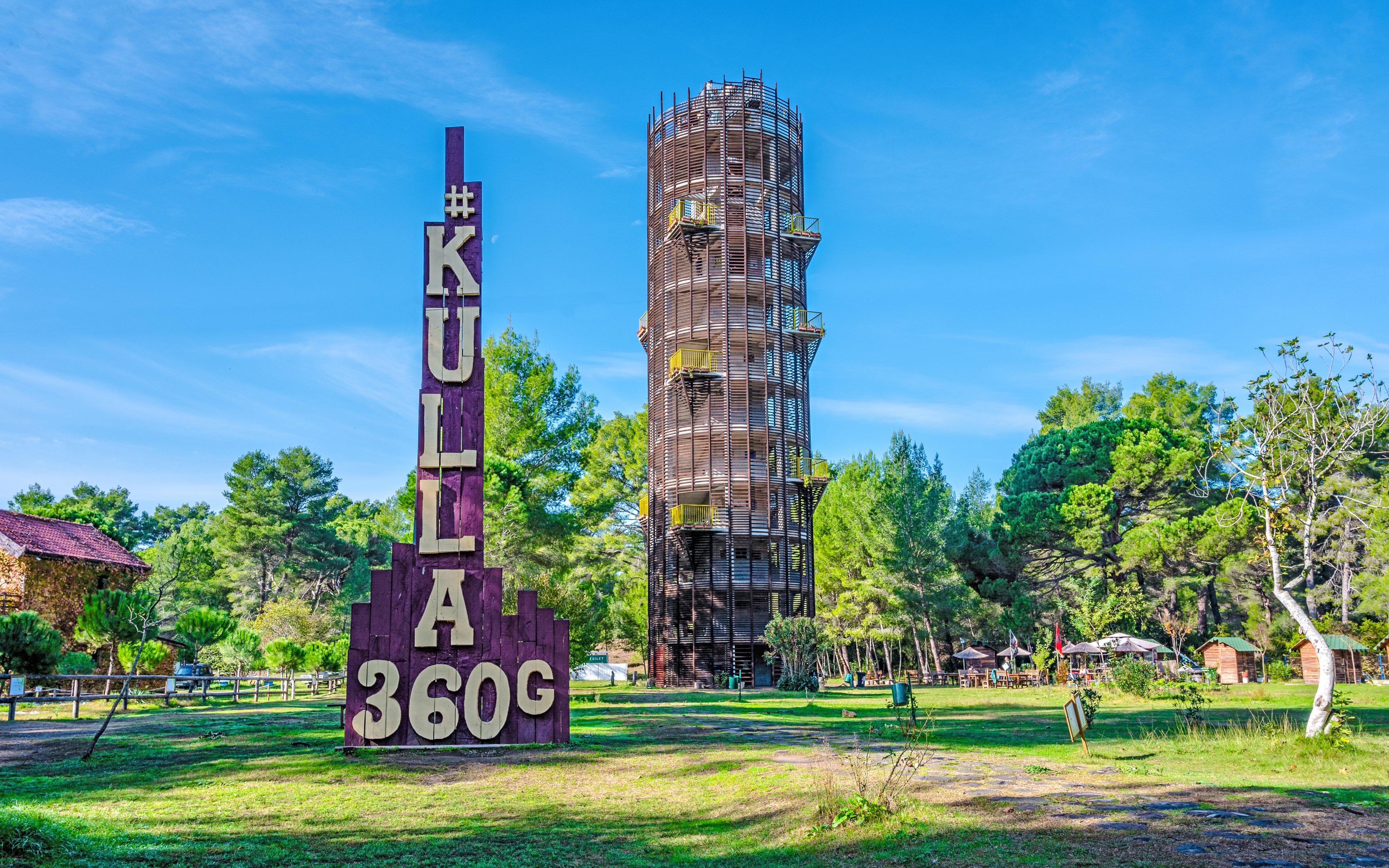 Panorama tower Kulla in Karavasta Lagoon, Albania surrounded by trees.