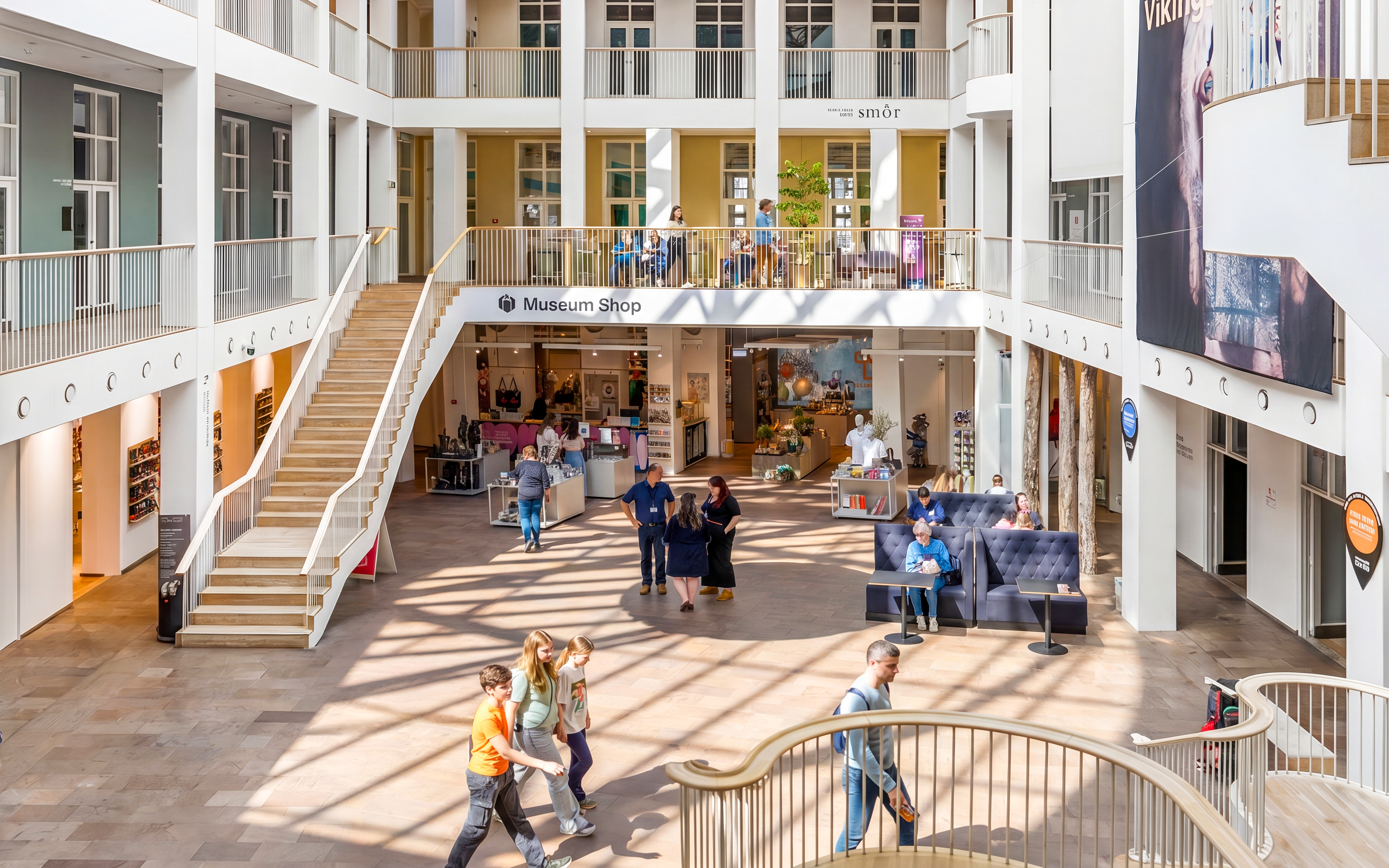 Welcome area of The National Museum of Denmark with visitors and museum shop.