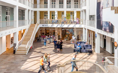 Welcome area of The National Museum of Denmark with visitors and museum shop.