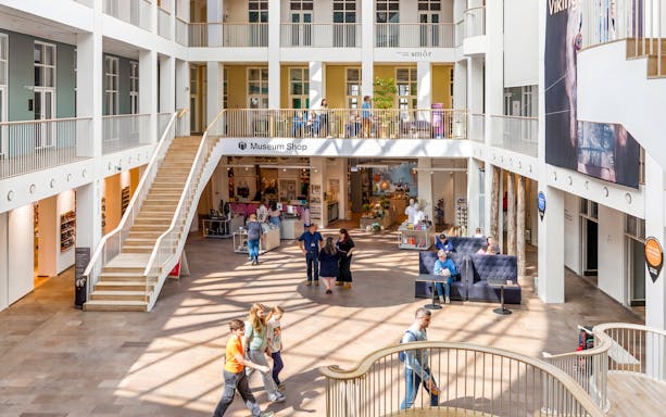 Welcome area of The National Museum of Denmark with visitors and museum shop.