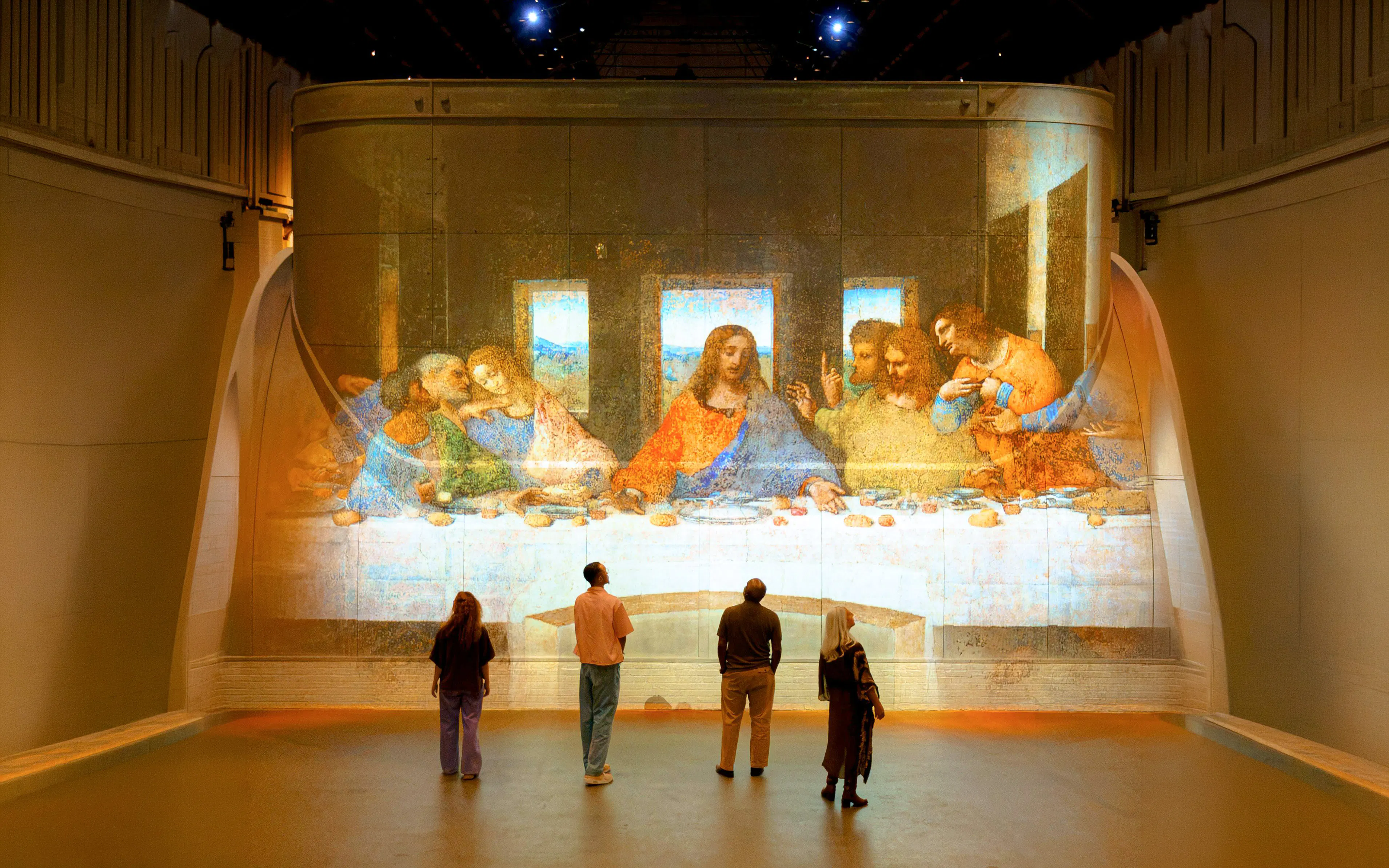 Visitors viewing The Last Supper projection at Fabrique des Lumières exhibit.