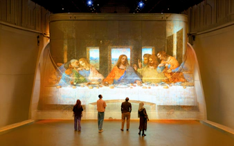 Visitors viewing The Last Supper projection at Fabrique des Lumières exhibit.