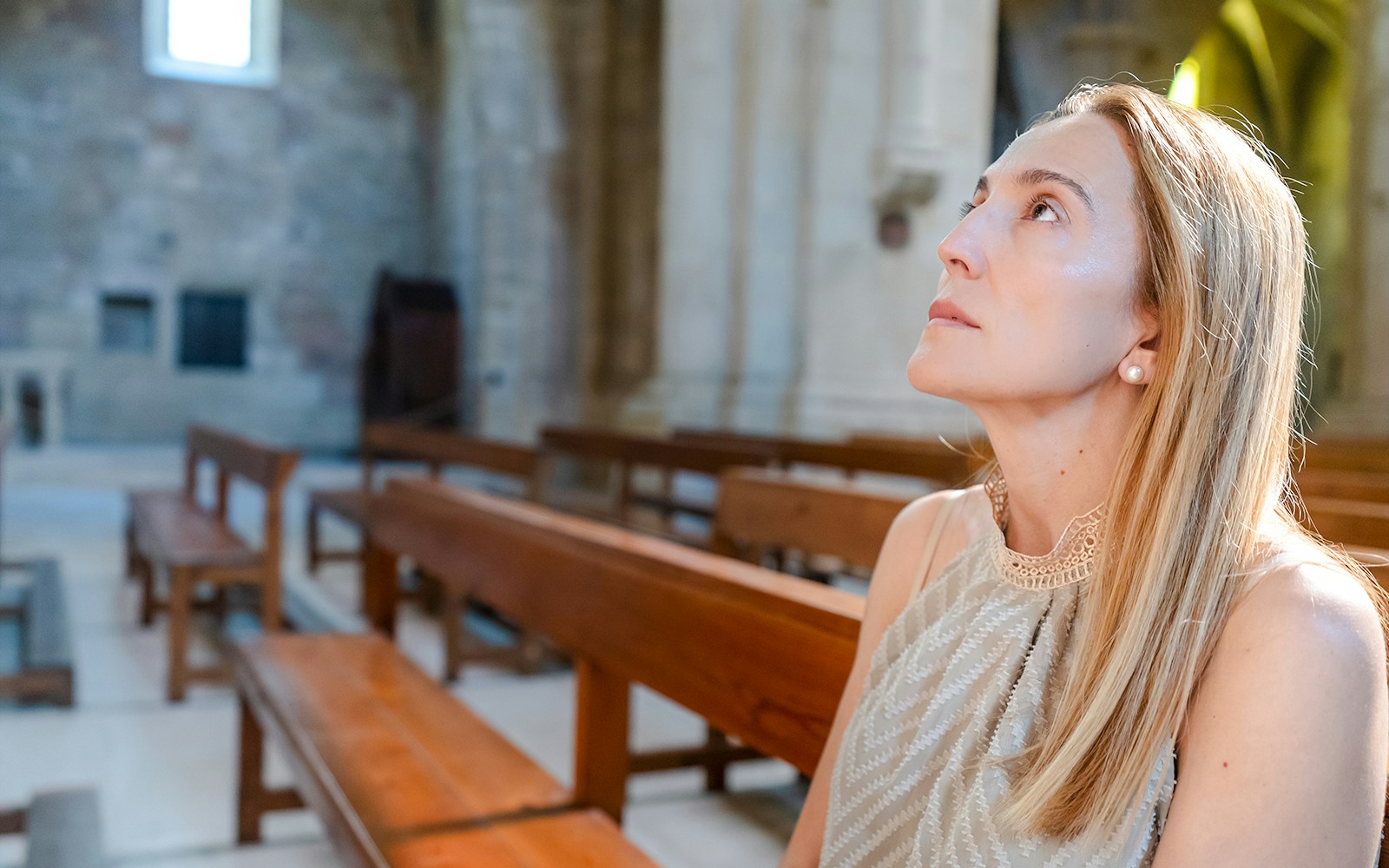 Visitor seated inside Christ the Redeemer Church chapel, looking upwards.