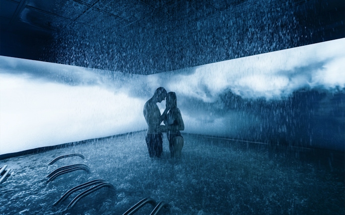 Couple enjoying a rain shower experience at QC Terme Milano spa.