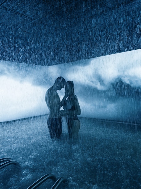 Couple enjoying a rain shower experience at QC Terme Milano spa.