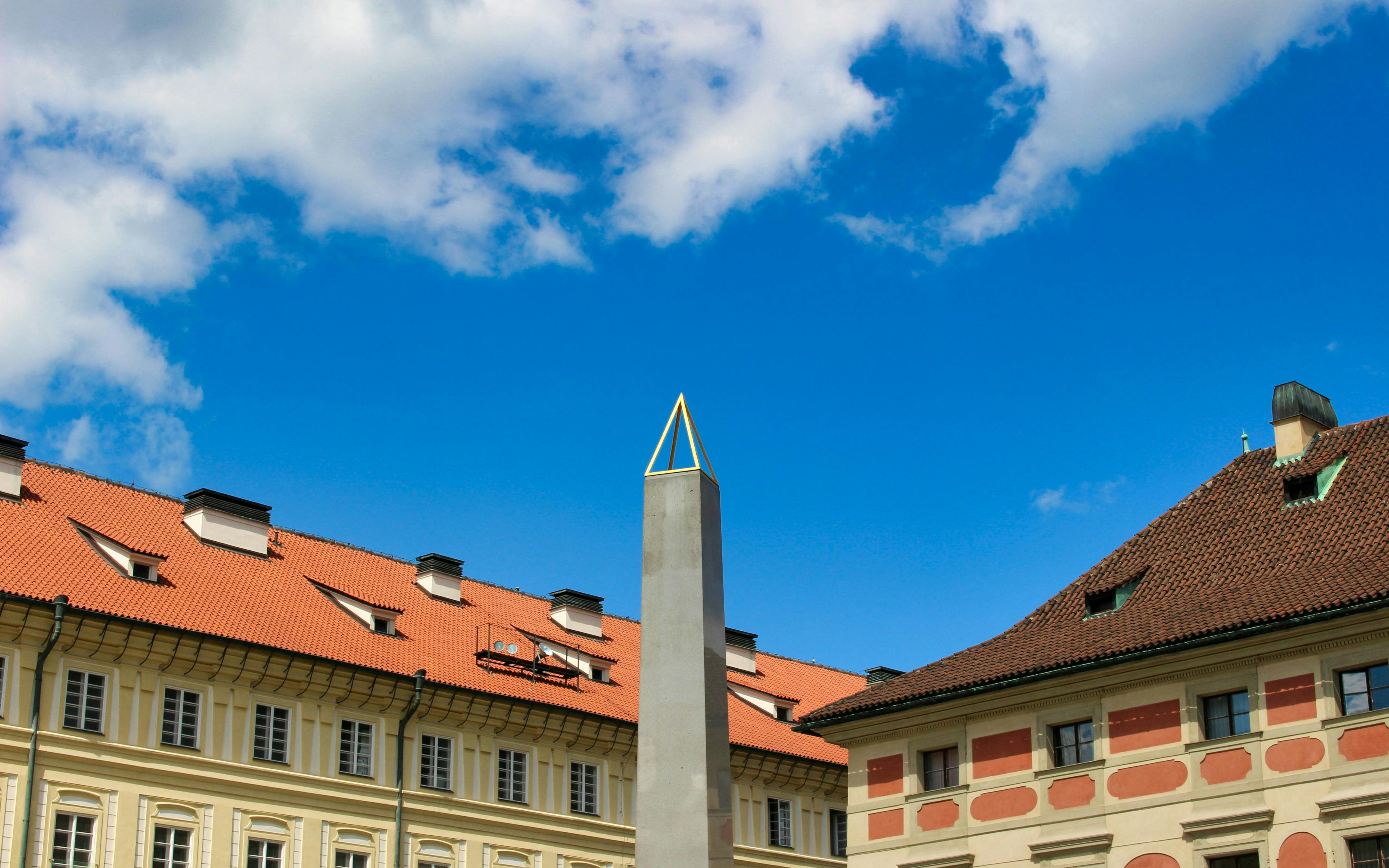 Obelisk at Prague Castle with historic buildings, Czech Republic.