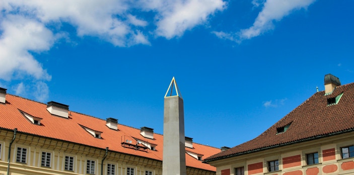 Obelisk at Prague Castle with historic buildings, Czech Republic.