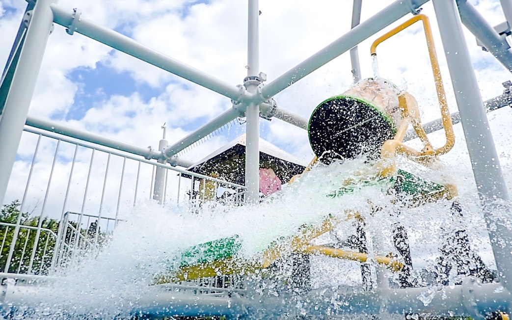 Water bucket splashes at Hakone Kowakien Yunessun water playground, Japan.