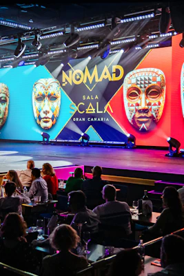 Performance at Sala Scala Gran Canaria with colorful masks and audience.