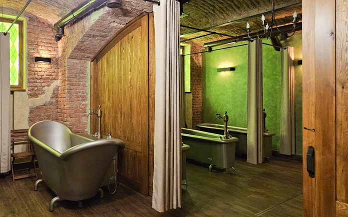 Luxurious spa bath tubs in a rustic brick and wood interior setting.