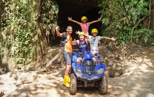 Family on ATV in Bali jungle during guided tour.