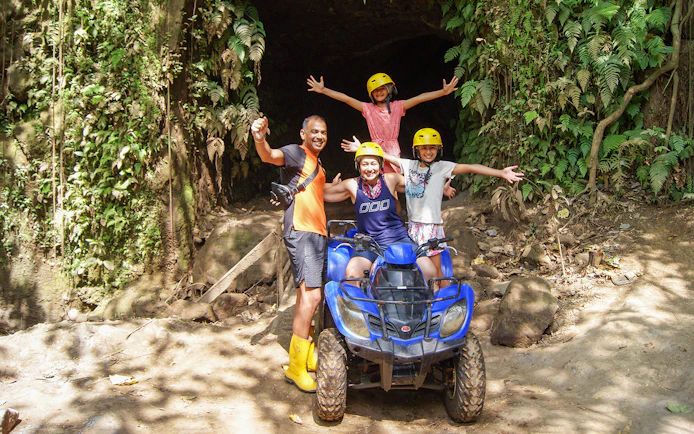 Family on ATV in Bali jungle during guided tour.
