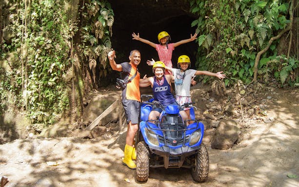 Family on ATV in Bali jungle during guided tour.