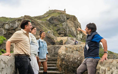 Tour group exploring San Juan de Gaztelugatxe islet, Basque Country, known as "Dragonstone" in Game of Thrones.