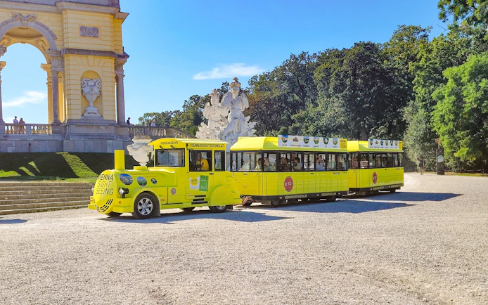 Yellow panoramic train at Schonbrunn Palace, Vienna, with Gloriette in the background.