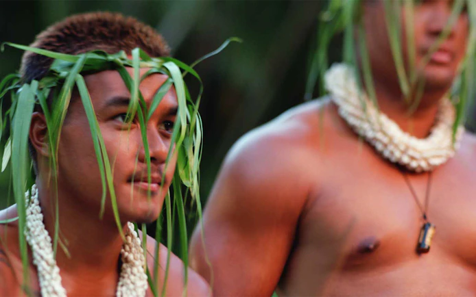 Men wearing traditional Hawaiian attire at Smiths Family Garden Luau.