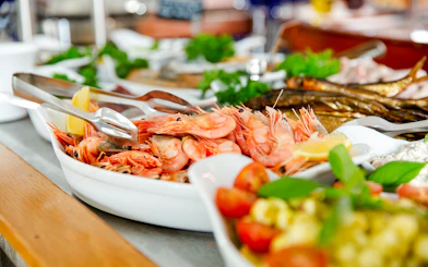 Shrimp buffet with lemon wedges and fresh herbs on a serving platter.