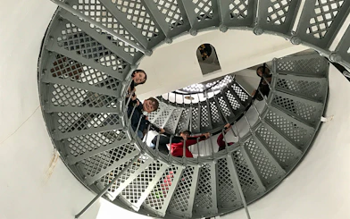 Visitors ascending spiral staircase inside Bruny Island lighthouse, Hobart tour.