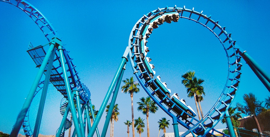 Roller coaster loop at Knott's Berry Farm with palm trees in the background.