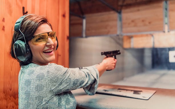 Person shooting at a target in a Warsaw shooting range.