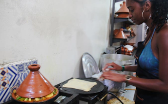 Woman preparing traditional Moroccan dish in a cooking class, Agadir.