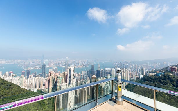 Skyline view of Hong Kong from Sky Terrace 428 with binoculars in the foreground.
