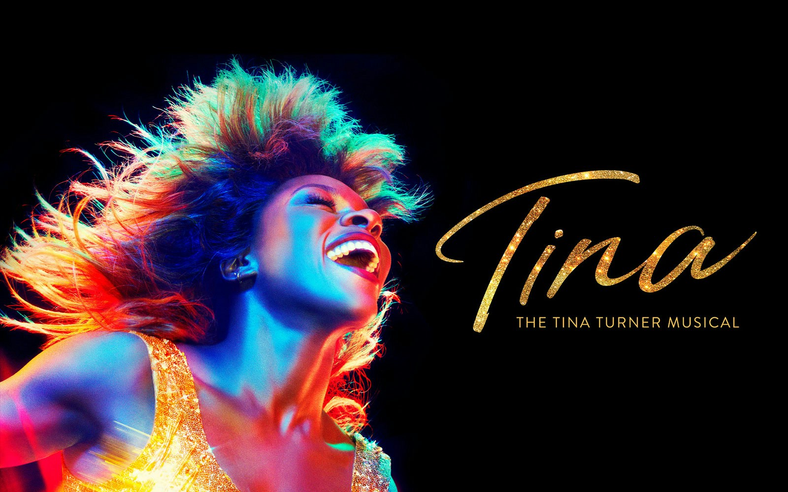 Performer in vibrant lighting for TINA: The Tina Turner Musical.