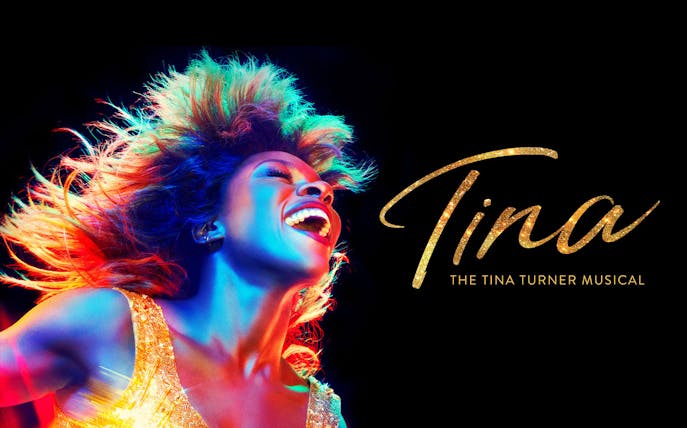 Performer in vibrant lighting for TINA: The Tina Turner Musical.
