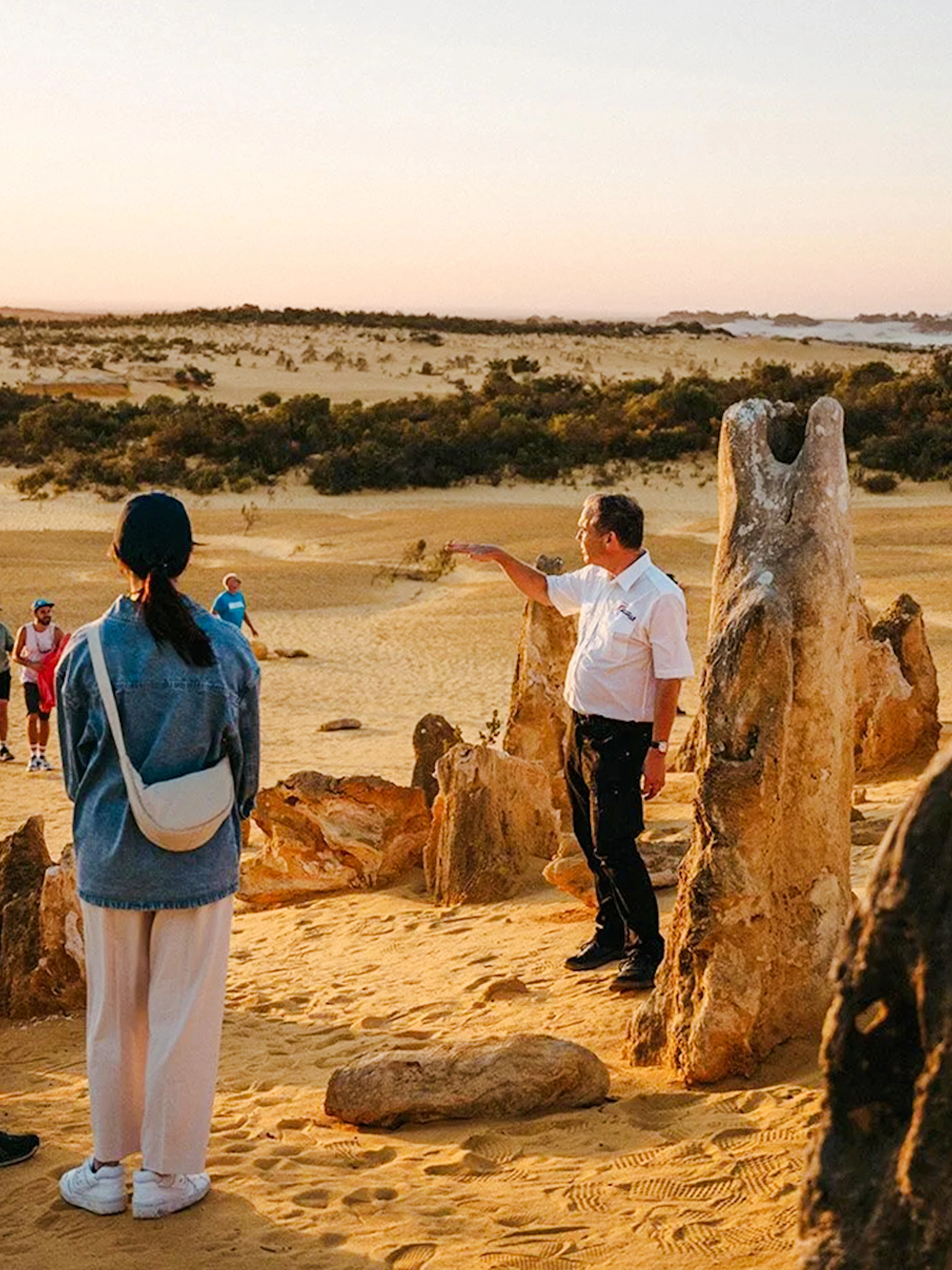 Group exploring Pinnacles Desert at sunset during stargazing and wildlife tour.