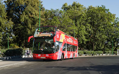 Double-decker sightseeing bus on a Hanoi city tour with tourists onboard.