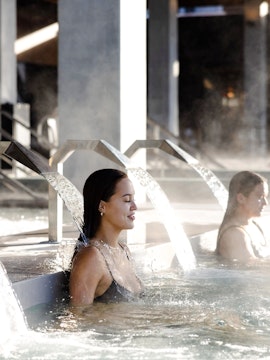 Women relaxing under water jets at Wai Ariki Hot Springs & Spa.