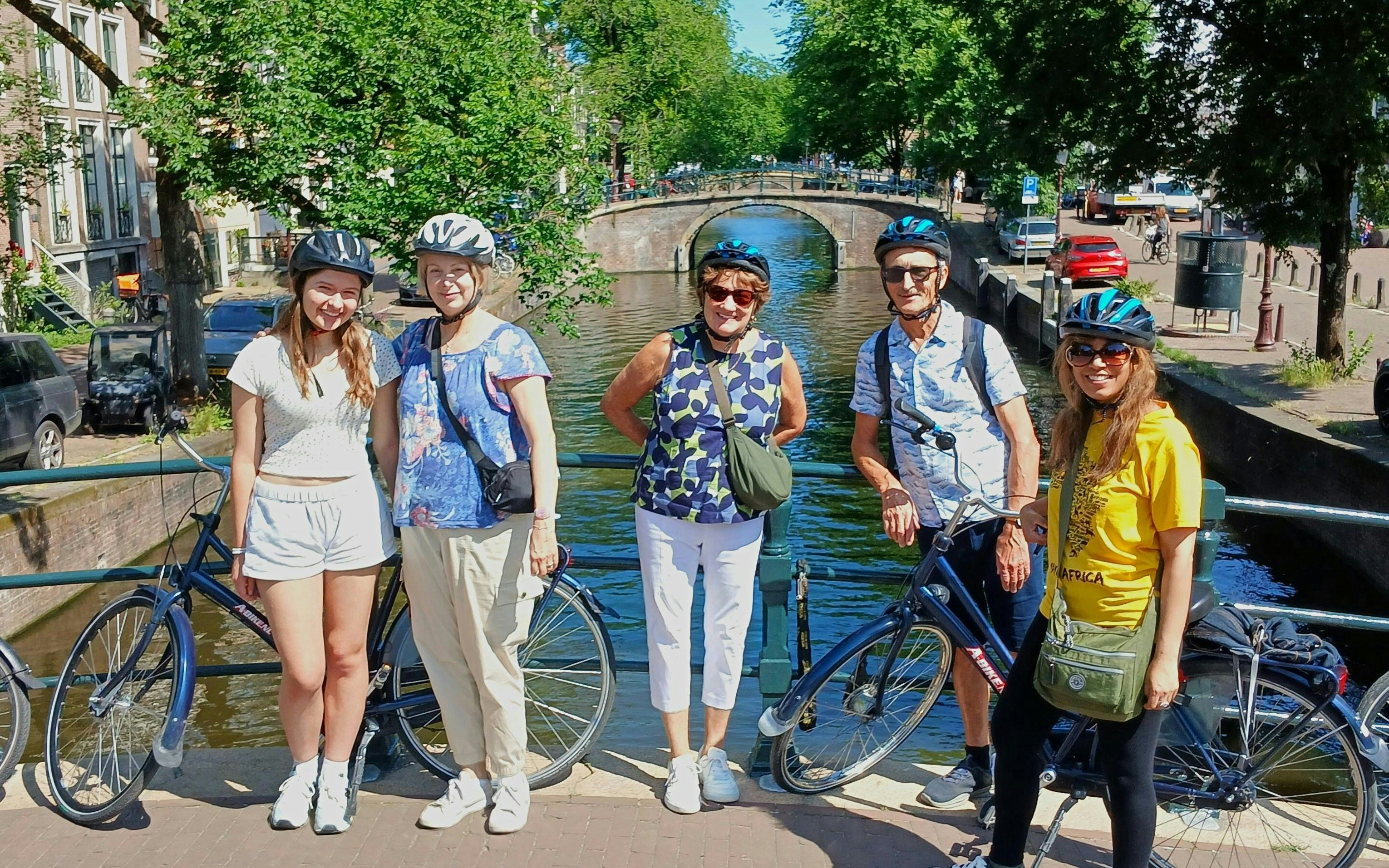 Group on a bike tour by a canal in Amsterdam.