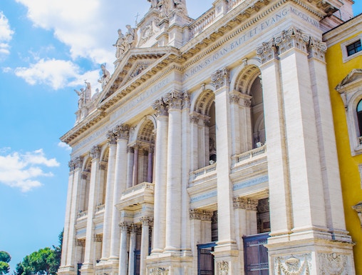 St. John Lateran Basilica facade with visitors in Rome, Italy.