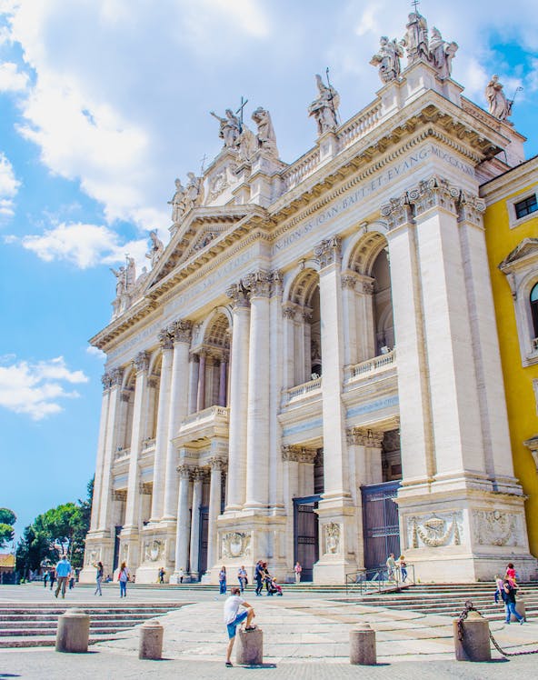 St. John Lateran Basilica facade with visitors in Rome, Italy.